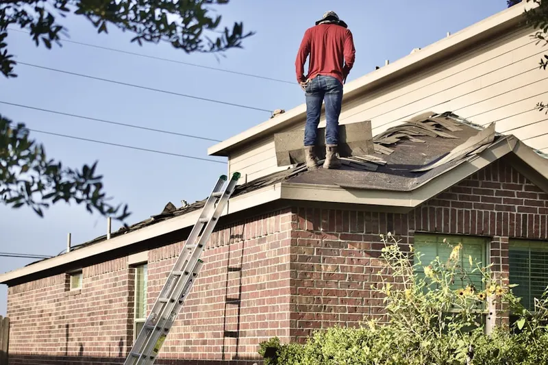 Professional roofer working on a residential roof in Dodge Park